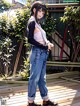 A woman standing on a wooden deck in front of a building.