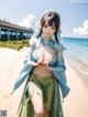 A woman in a blue and green kimono standing on a beach.