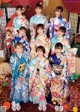 A group of women in kimonos posing for a picture.