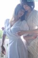 A couple of women standing next to each other on a balcony.